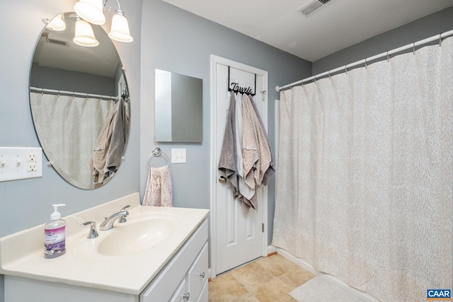 bathroom with vanity, visible vents, and a notable chandelier