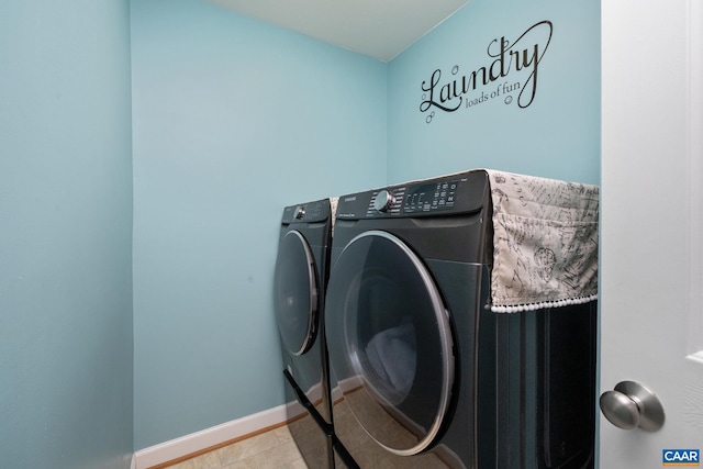 laundry room with washing machine and dryer, laundry area, and baseboards