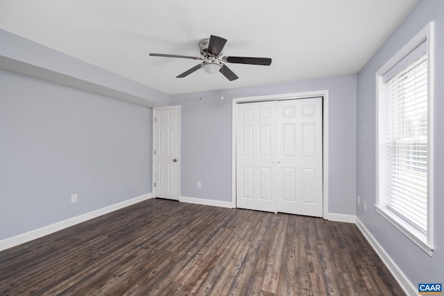 unfurnished bedroom with a ceiling fan, a closet, dark wood finished floors, and baseboards