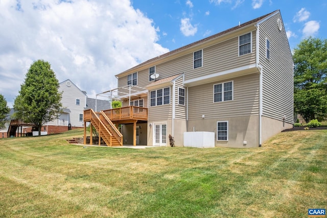 rear view of house featuring a deck, a yard, and stairs