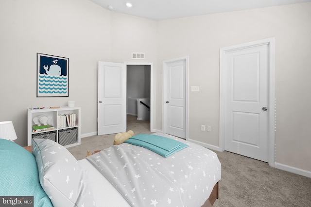 bedroom featuring light colored carpet, visible vents, and baseboards