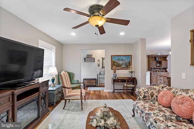 living room with ceiling fan, wood finished floors, and recessed lighting