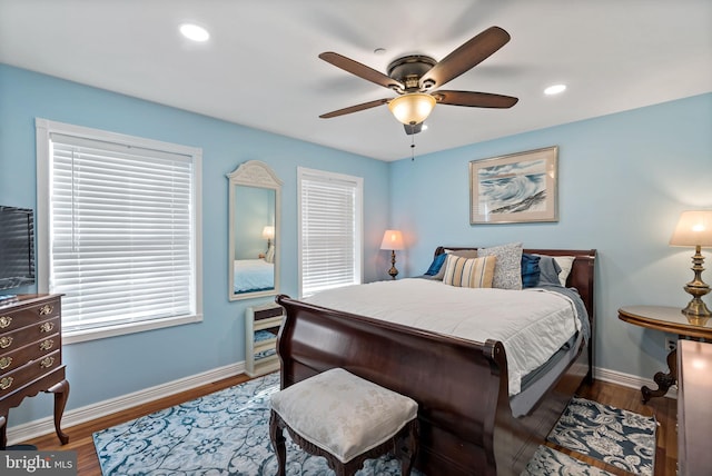 bedroom featuring a ceiling fan, recessed lighting, baseboards, and wood finished floors