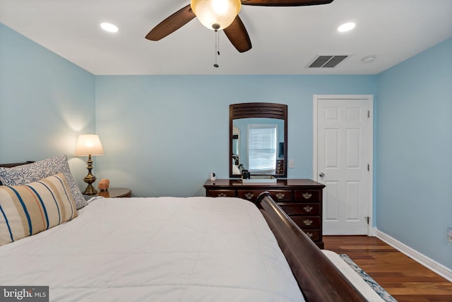 bedroom featuring baseboards, dark wood-style flooring, visible vents, and recessed lighting