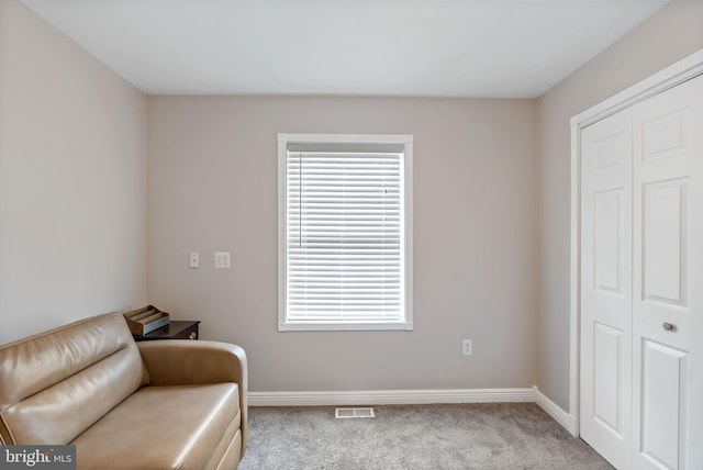 sitting room featuring carpet, visible vents, and baseboards