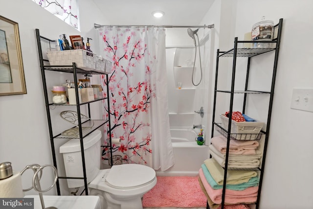 bathroom with shower / tub combo with curtain and toilet