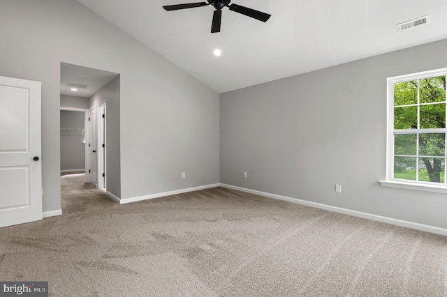 carpeted spare room featuring high vaulted ceiling, visible vents, baseboards, and a ceiling fan