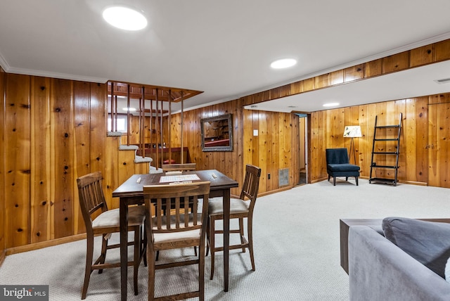 dining room featuring crown molding, carpet, stairs, and baseboards