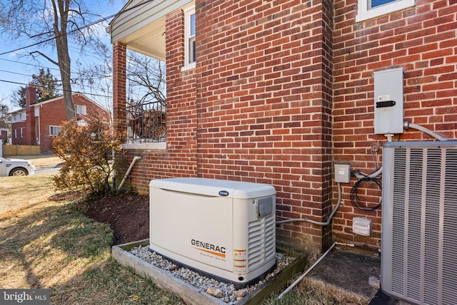 exterior details with a power unit, central AC unit, and brick siding