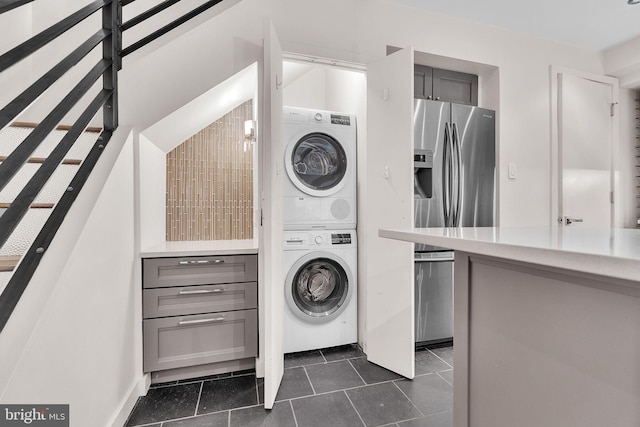 laundry room featuring laundry area and stacked washer / drying machine