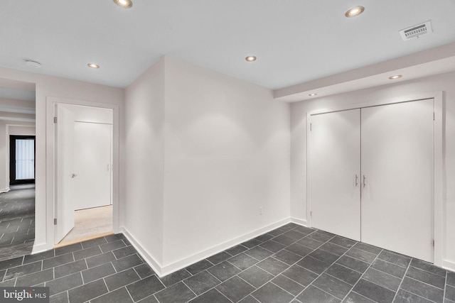 foyer entrance with baseboards, visible vents, and recessed lighting