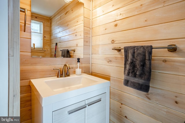 bathroom featuring vanity and wood walls