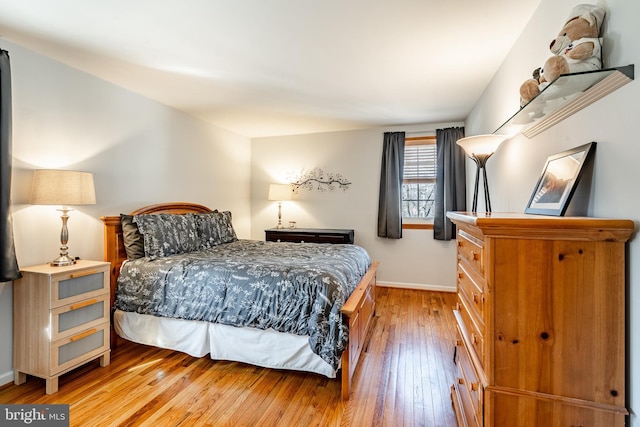 bedroom featuring light wood-style floors and baseboards