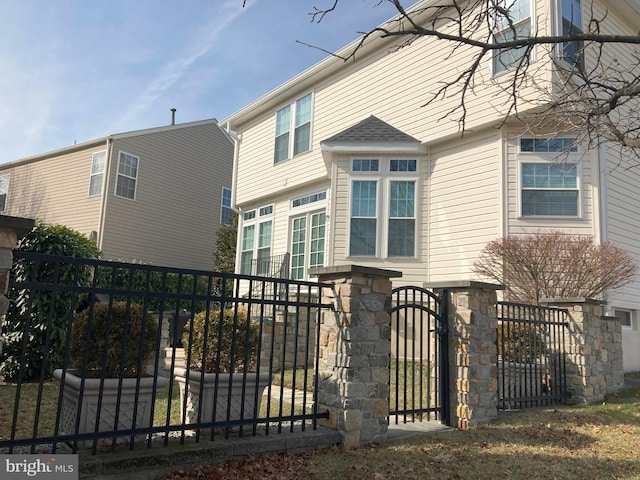 view of front of house with a fenced front yard and a gate