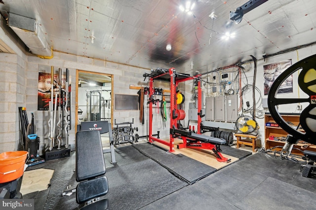 gym featuring concrete block wall