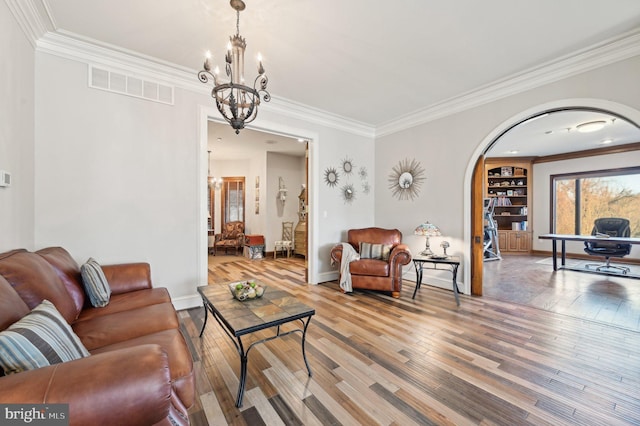 living room featuring arched walkways, visible vents, a notable chandelier, and hardwood / wood-style flooring