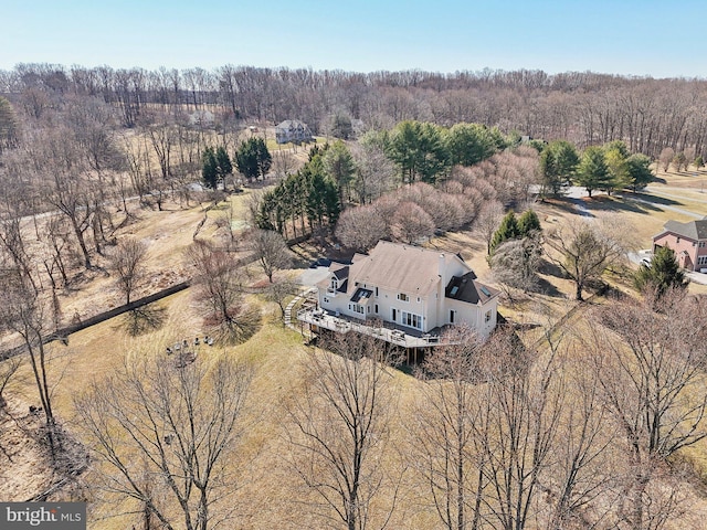 birds eye view of property featuring a view of trees