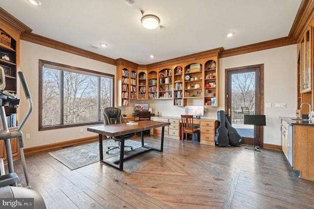 home office with a sink, baseboards, and crown molding