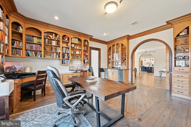 office featuring visible vents, hardwood / wood-style flooring, recessed lighting, arched walkways, and crown molding