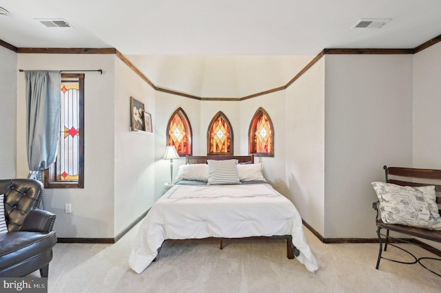 bedroom with visible vents, baseboards, crown molding, and carpet