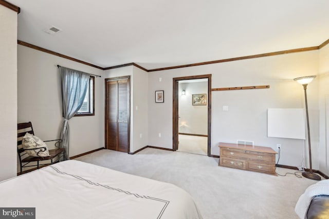 bedroom featuring visible vents, ornamental molding, a closet, carpet, and baseboards