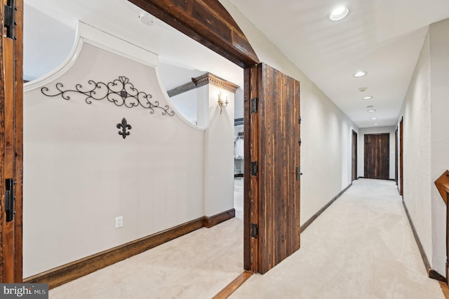 hall featuring recessed lighting, baseboards, and light colored carpet