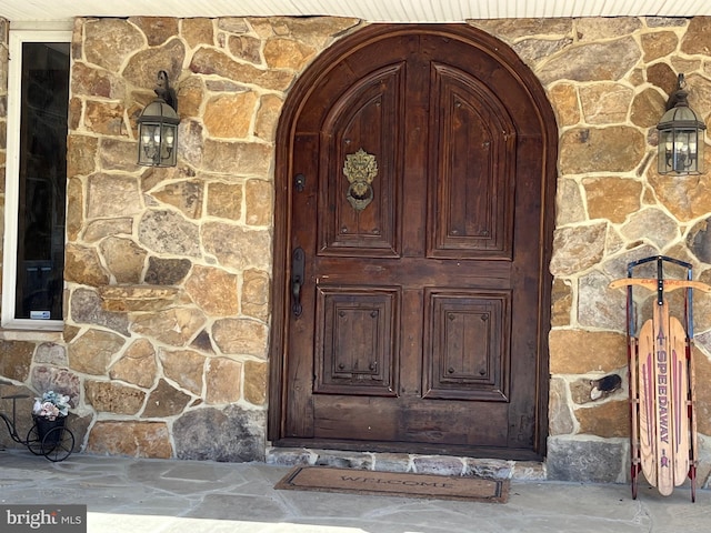 entrance to property with stone siding