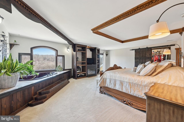 bedroom with a fireplace, a barn door, and carpet