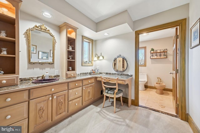 full bathroom featuring tile patterned flooring, baseboards, toilet, a bidet, and vanity