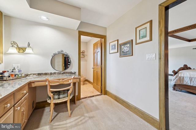 full bathroom featuring vanity, ensuite bathroom, and baseboards