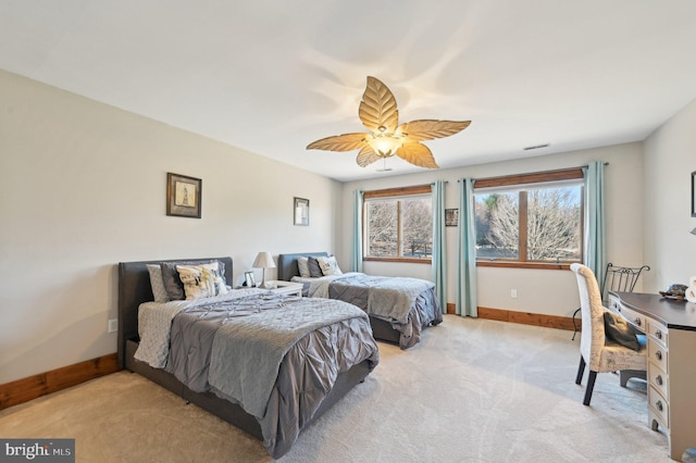 bedroom featuring baseboards, light carpet, and a ceiling fan