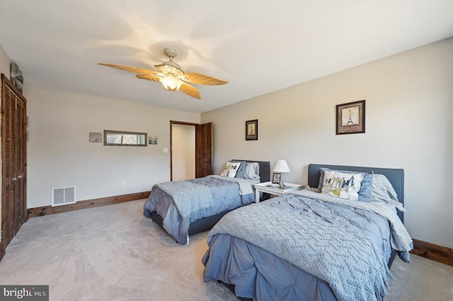 carpeted bedroom featuring baseboards, visible vents, and ceiling fan