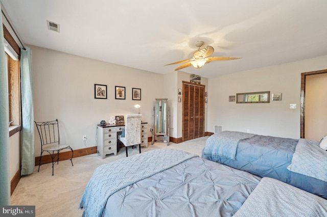 bedroom with light carpet, visible vents, a ceiling fan, and baseboards