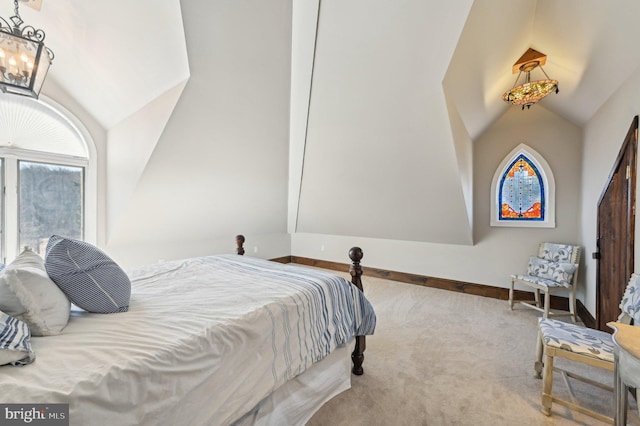 carpeted bedroom with a notable chandelier, baseboards, and lofted ceiling