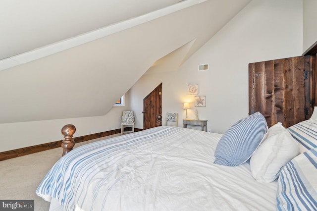 bedroom with visible vents, baseboards, lofted ceiling, and carpet