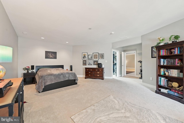 bedroom with baseboards and light carpet