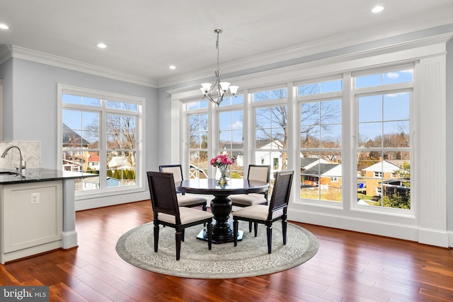 dining room featuring a chandelier, ornamental molding, dark wood-style flooring, and recessed lighting