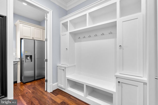 mudroom featuring ornamental molding and dark wood finished floors