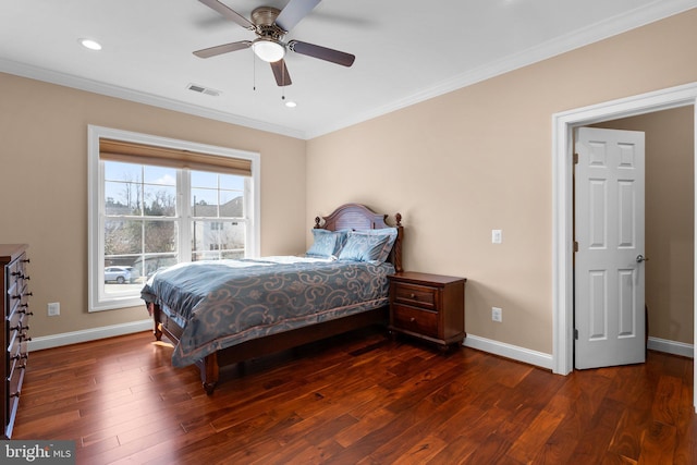 bedroom featuring ornamental molding, wood finished floors, visible vents, and baseboards