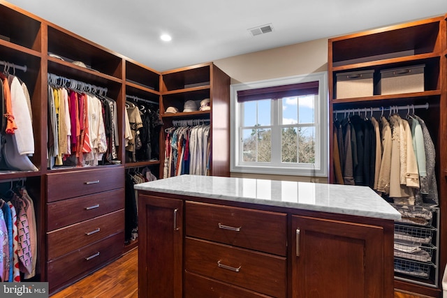 walk in closet with dark wood-type flooring and visible vents