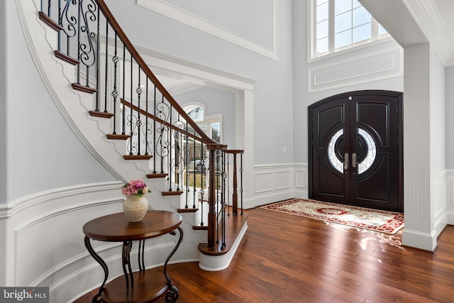 entrance foyer featuring plenty of natural light, hardwood / wood-style flooring, and a decorative wall