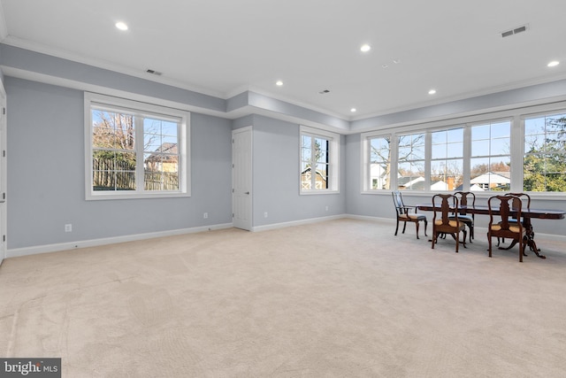 dining area with light carpet, visible vents, baseboards, plenty of natural light, and crown molding