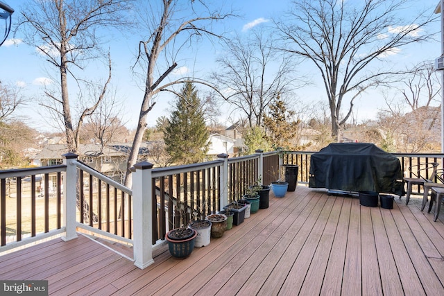 wooden terrace with a grill