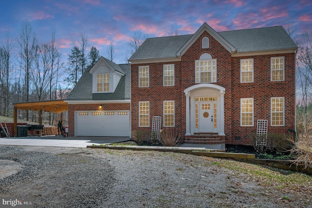 view of front of house with concrete driveway, a shingled roof, a garage, an attached carport, and brick siding