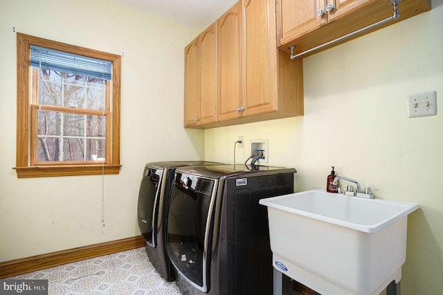 washroom with washer and clothes dryer, cabinet space, baseboards, and a sink