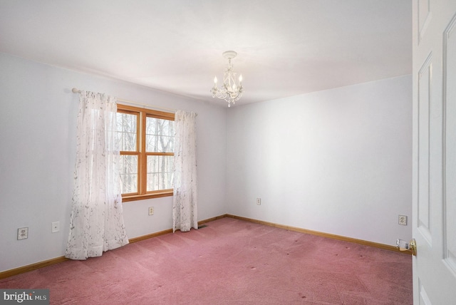 unfurnished room featuring a notable chandelier, baseboards, and carpet floors