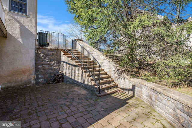 view of patio / terrace with stairs and central AC unit