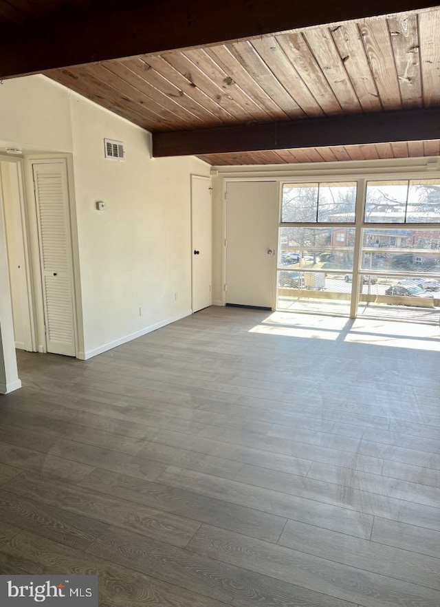 interior space featuring lofted ceiling with beams, wooden ceiling, wood finished floors, visible vents, and baseboards