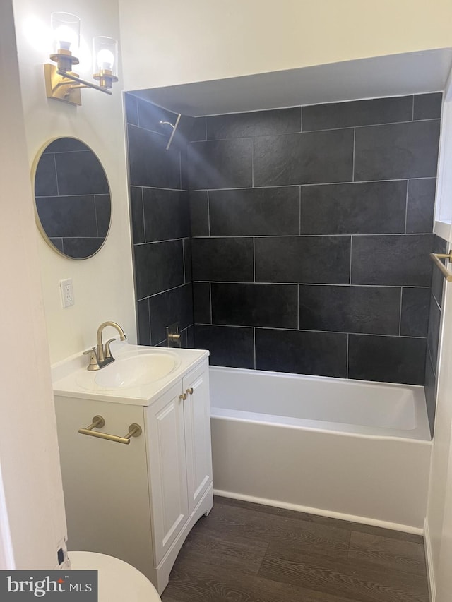 full bath with shower / bathing tub combination, vanity, toilet, and wood finished floors