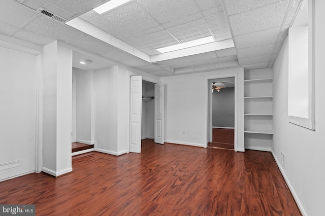 interior space with baseboards, a closet, visible vents, and wood finished floors